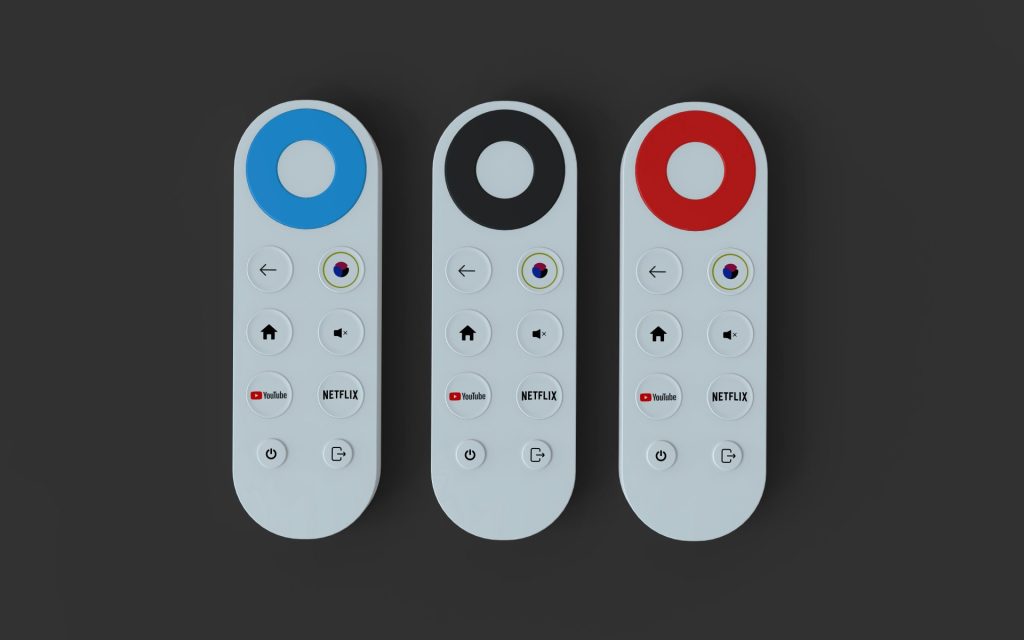 Three white remote controls with different colored tops.