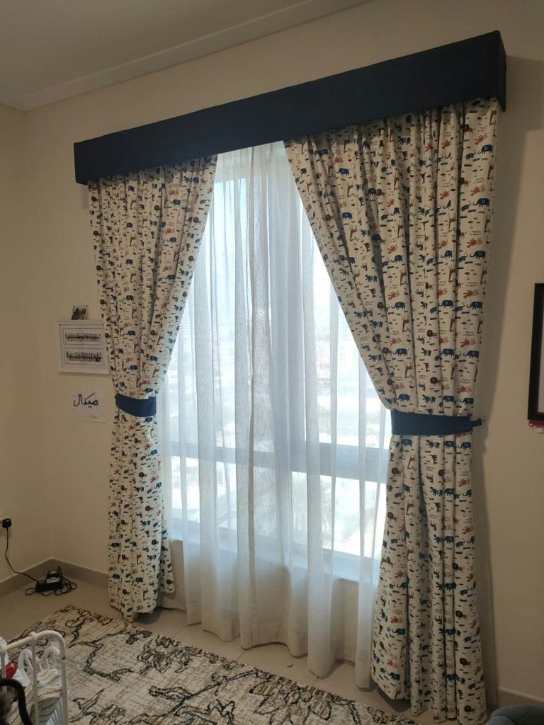 a bed room with a neatly made bed and curtains