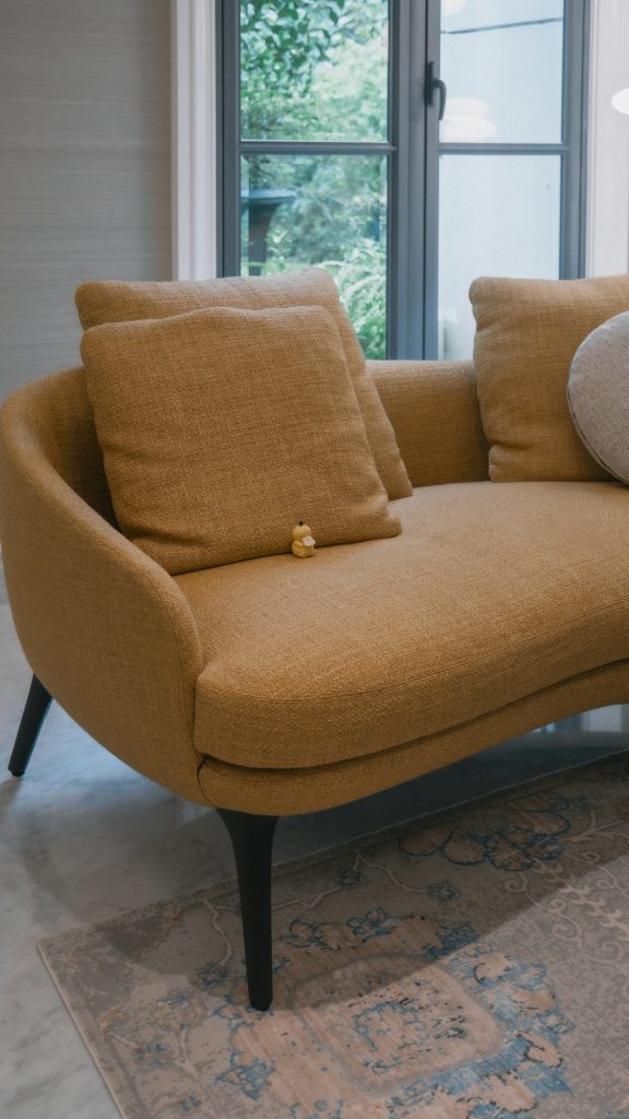 A living room with a couch and a lamp